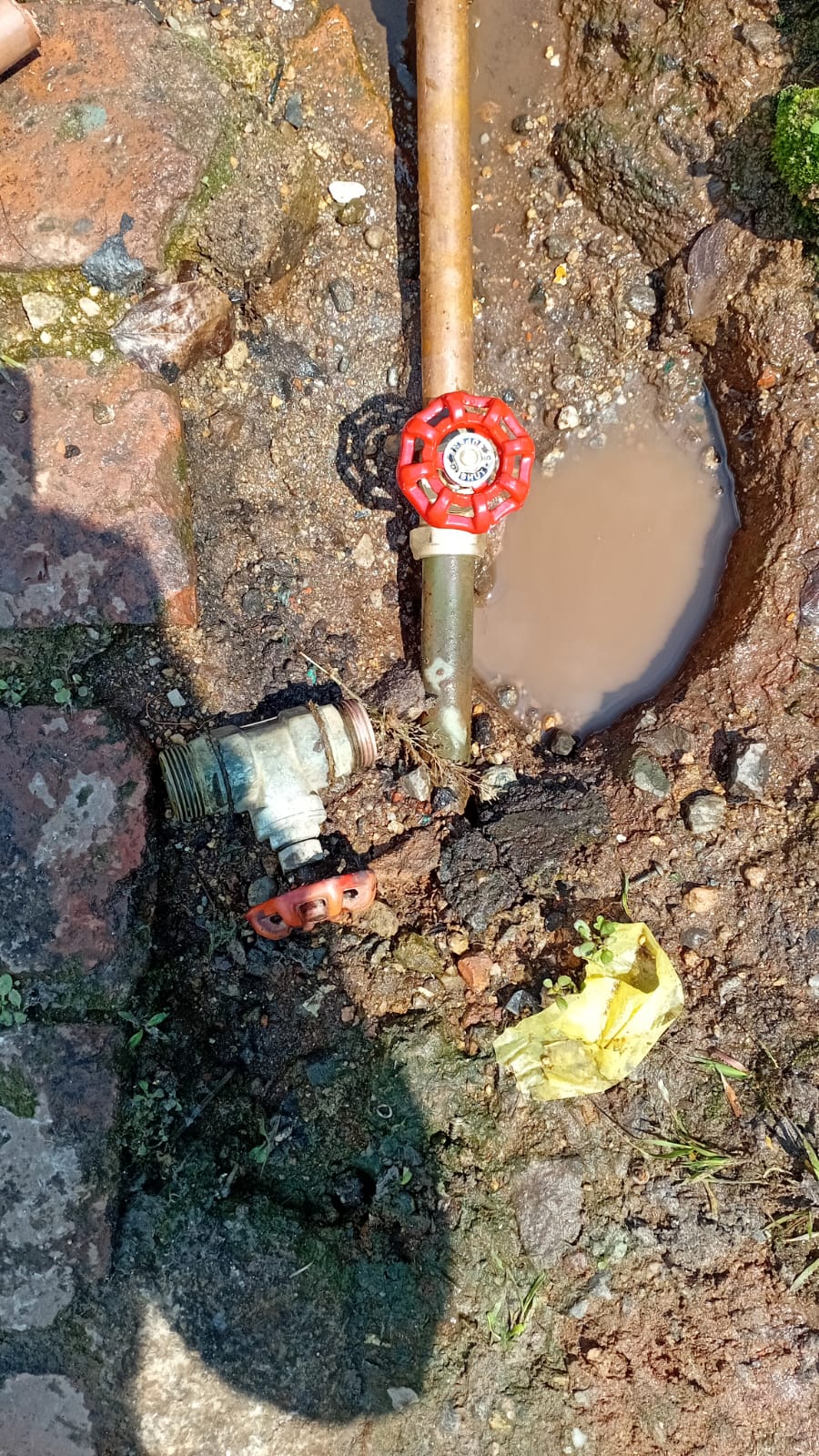 Plumber repairing an active underground water leak
