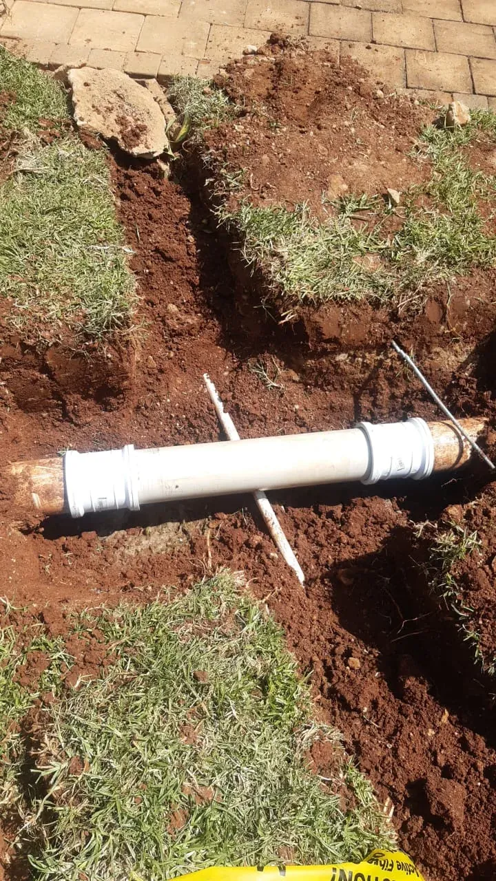 New PVC underground drainage pipe installed after blockage damage